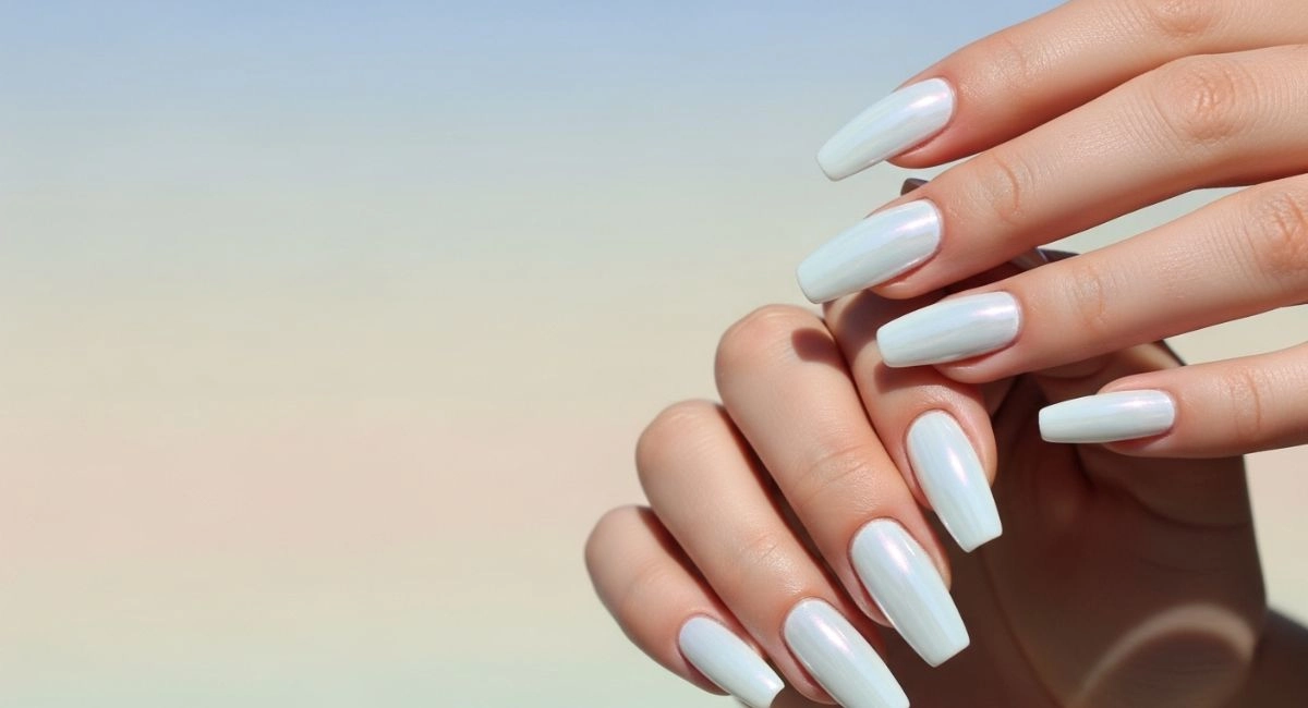 Shiny white chrome nails glowing in sunlight, showcasing the latest summer nail trends and elegant nail looks for 2025.